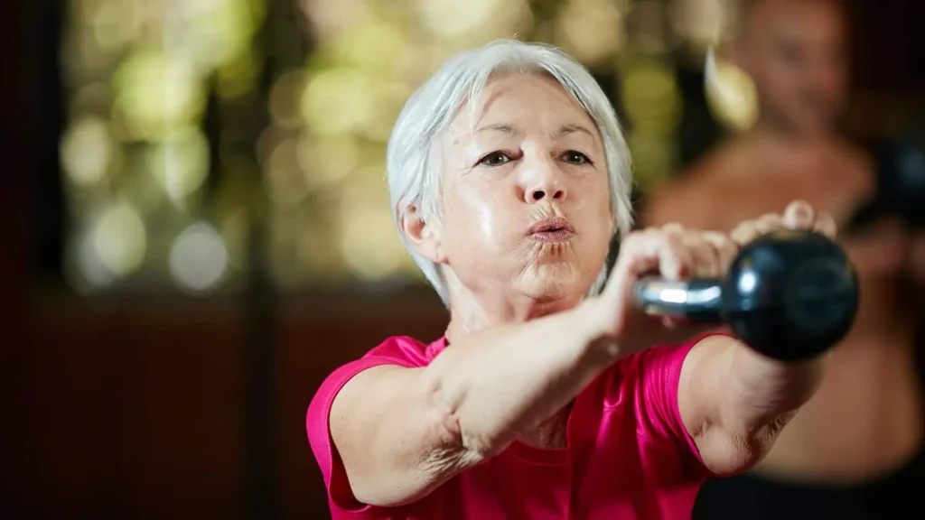 Toning Bingo Wings: Effective Exercises and Tips for Achieving Sleeker Arms 2 Person performing arm exercises with dumbbells Leicester