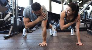 Image of man and woman doing Cardio Leicester to tone their arms. 